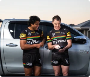 Two Penrith Panthers players wearing team gear and wearing branded merchandise, representing MyPlace becoming the principal partner of the Panthers in 2023.