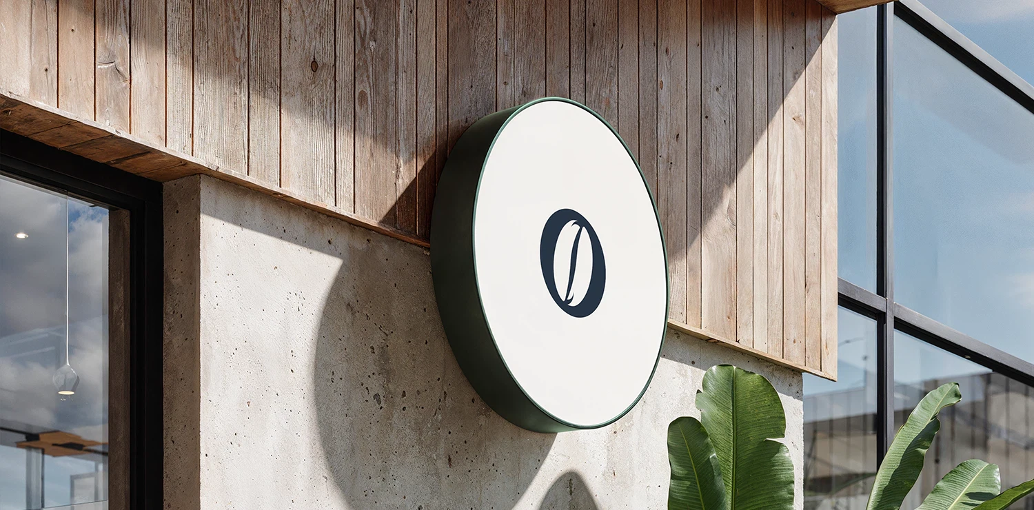 A dark café awning with the slogan “Coffee is not just a drink, it’s an experience,” highlighting the brand’s premium coffee identity.
