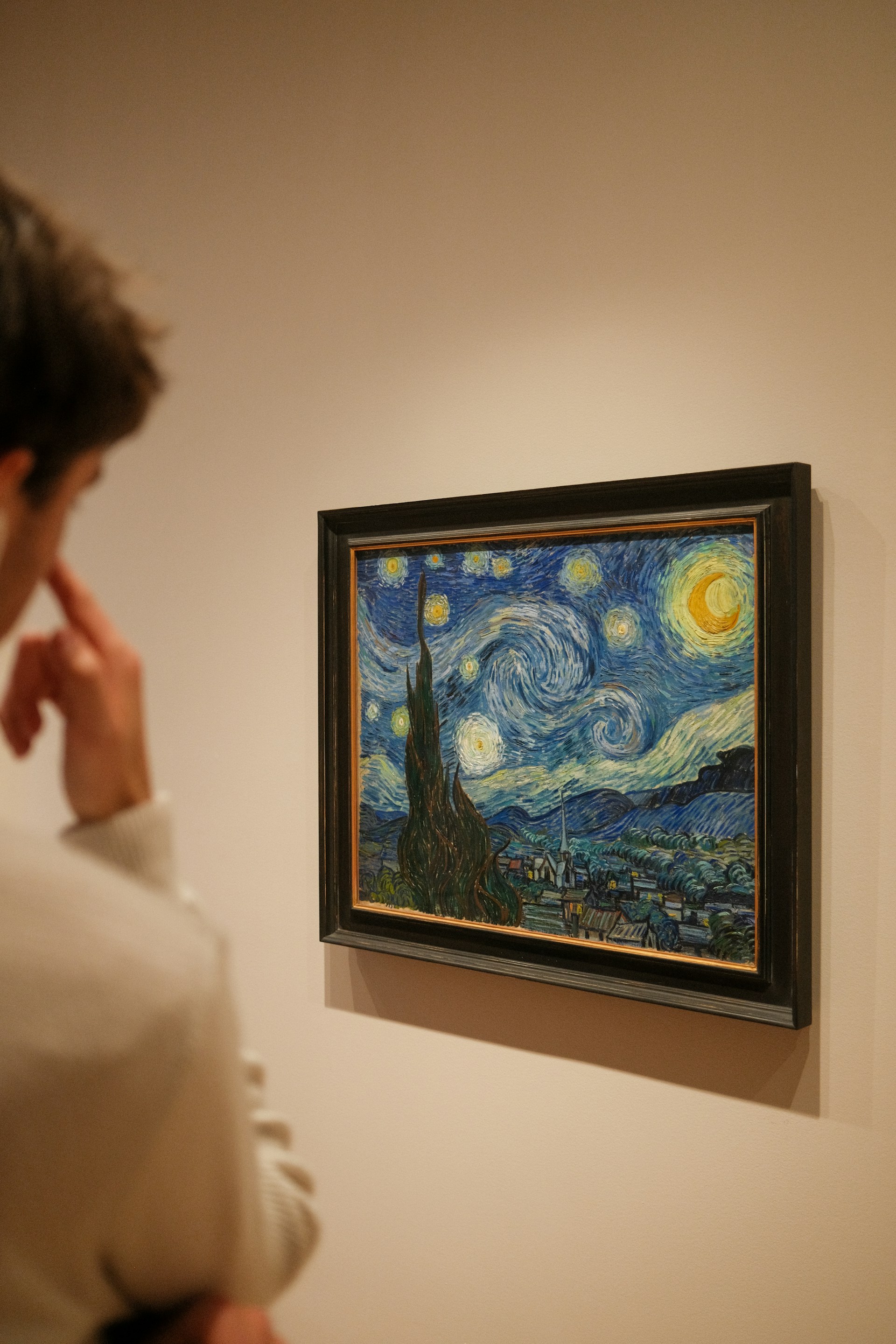 woman standing in front of paintings