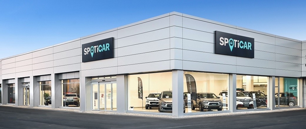 Esterno della concessionaria SPOTICAR con auto esposte nello showroom