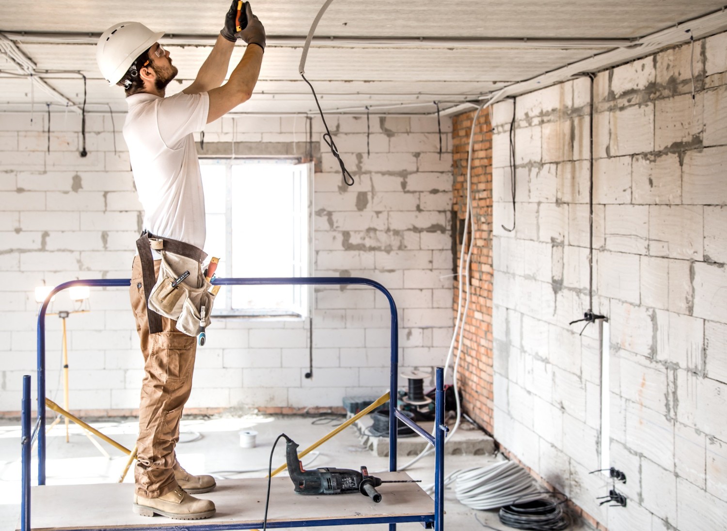 Technician inspects the light in a building site.
