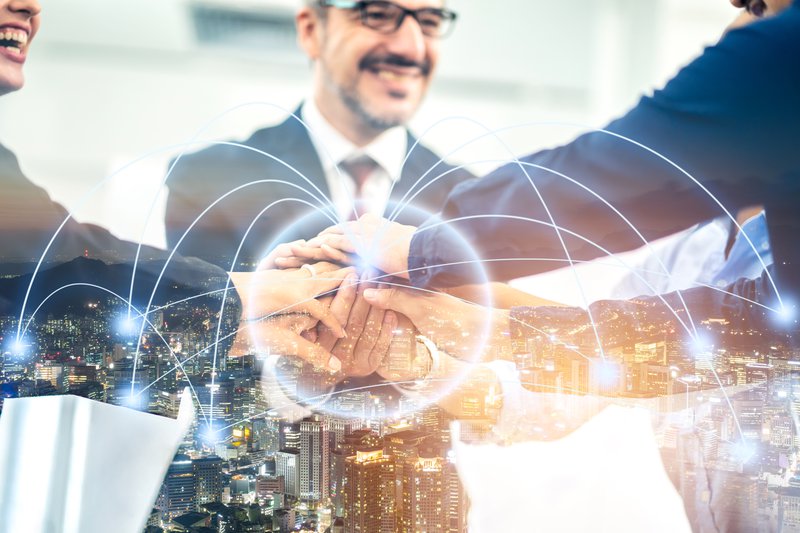 Group of business man and woman handshake with connection light effect link on transparent city map network graphic diagram, digital technology, internet communication, teamwork, partnership concept.