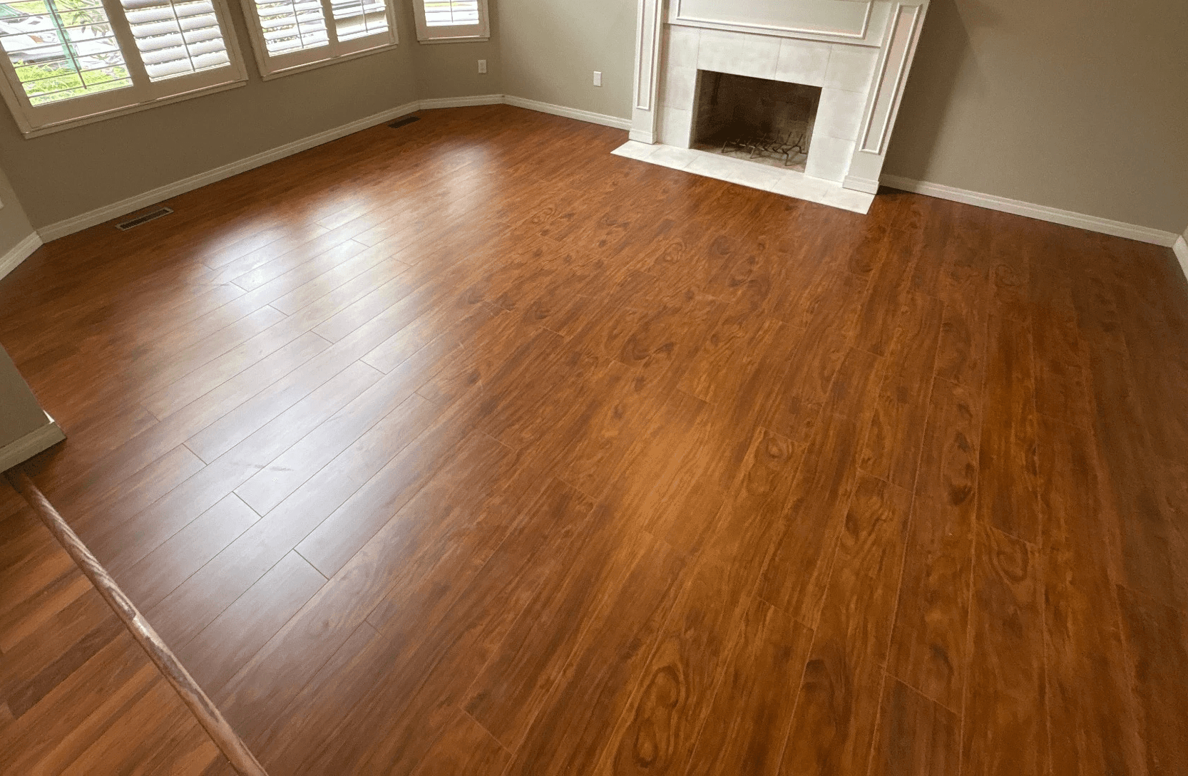 Living room after installation of new wood-look hard-surface flooring.