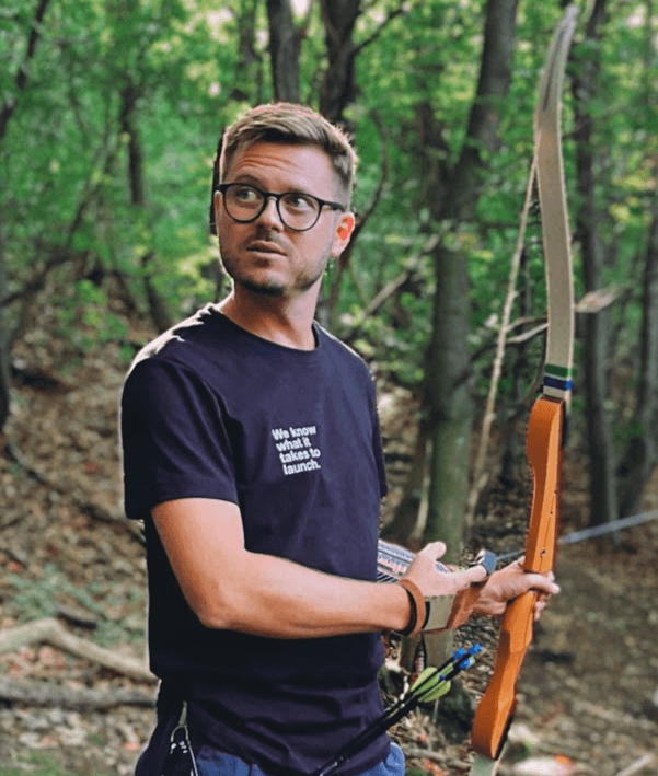 Stefan Silberfeld at a Team Event holding a bow & arrow.