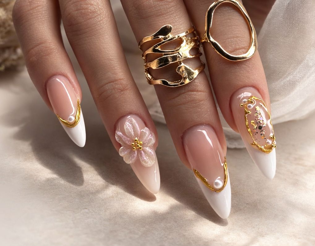 Woman applying cuticle oil with a dropper on manicured nails