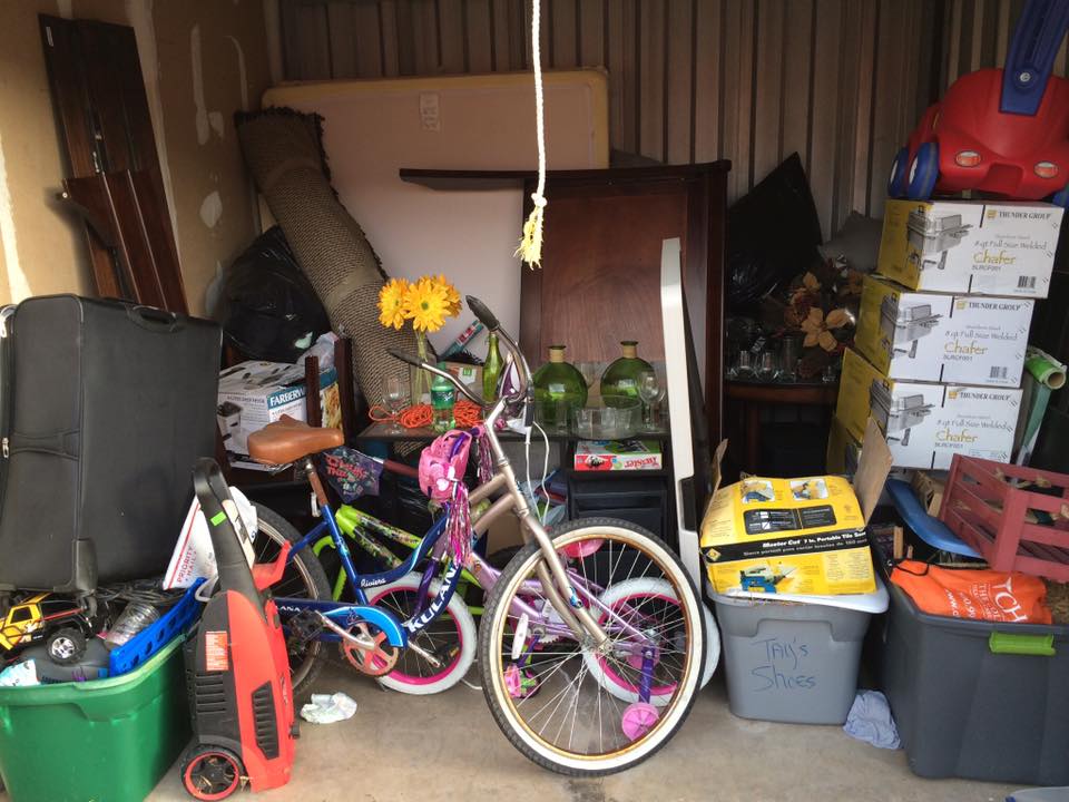 Hodges Family Movers provides efficient and reliable garage clean out services for decluttering and organizing your space in Sugar Land, TX - Photo of cluttered garaged to be cleaned out by HFM garage cleaners from Houston