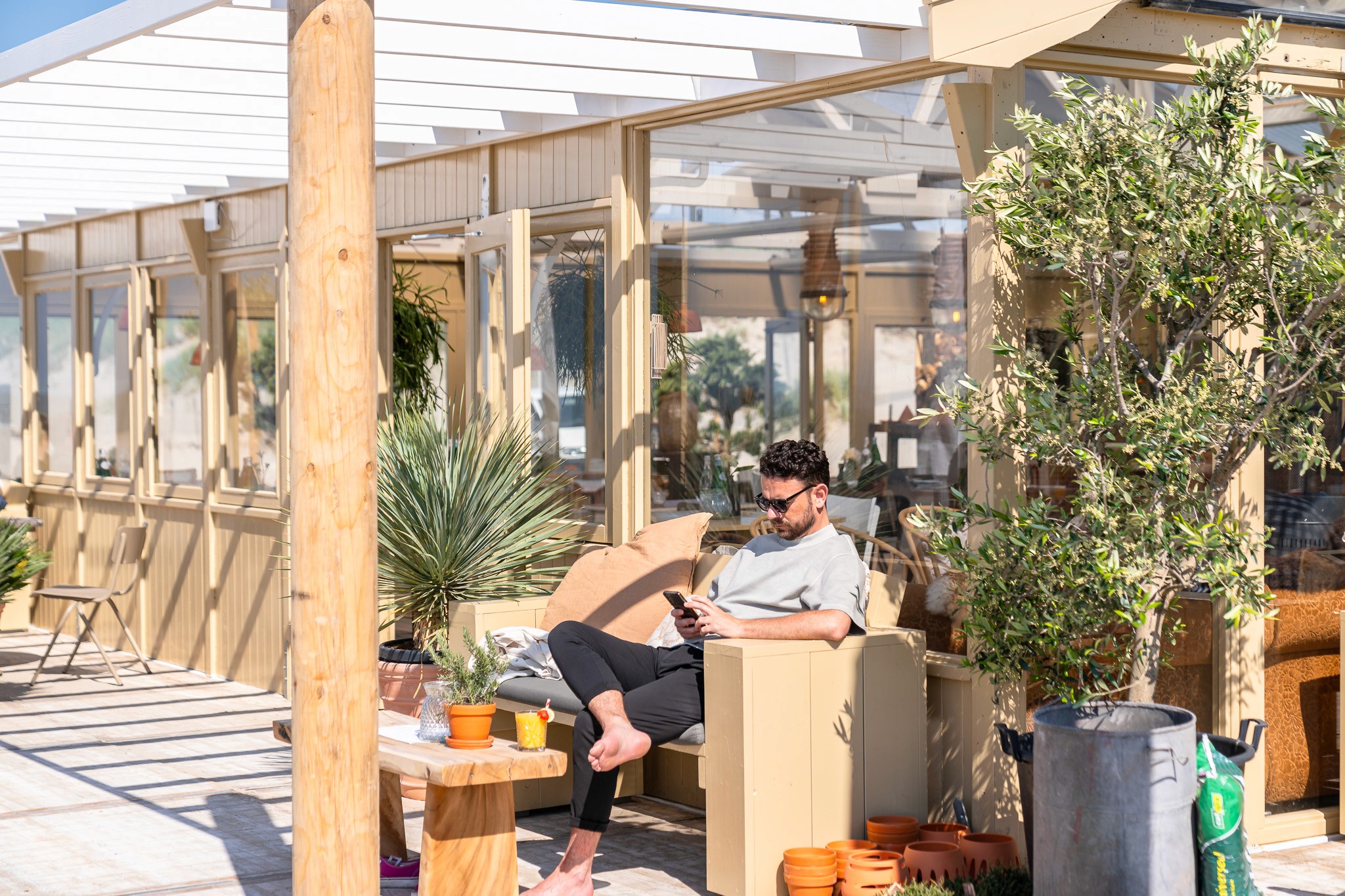 Man sitting on terrace at Bariloche Beach Club in The Hague