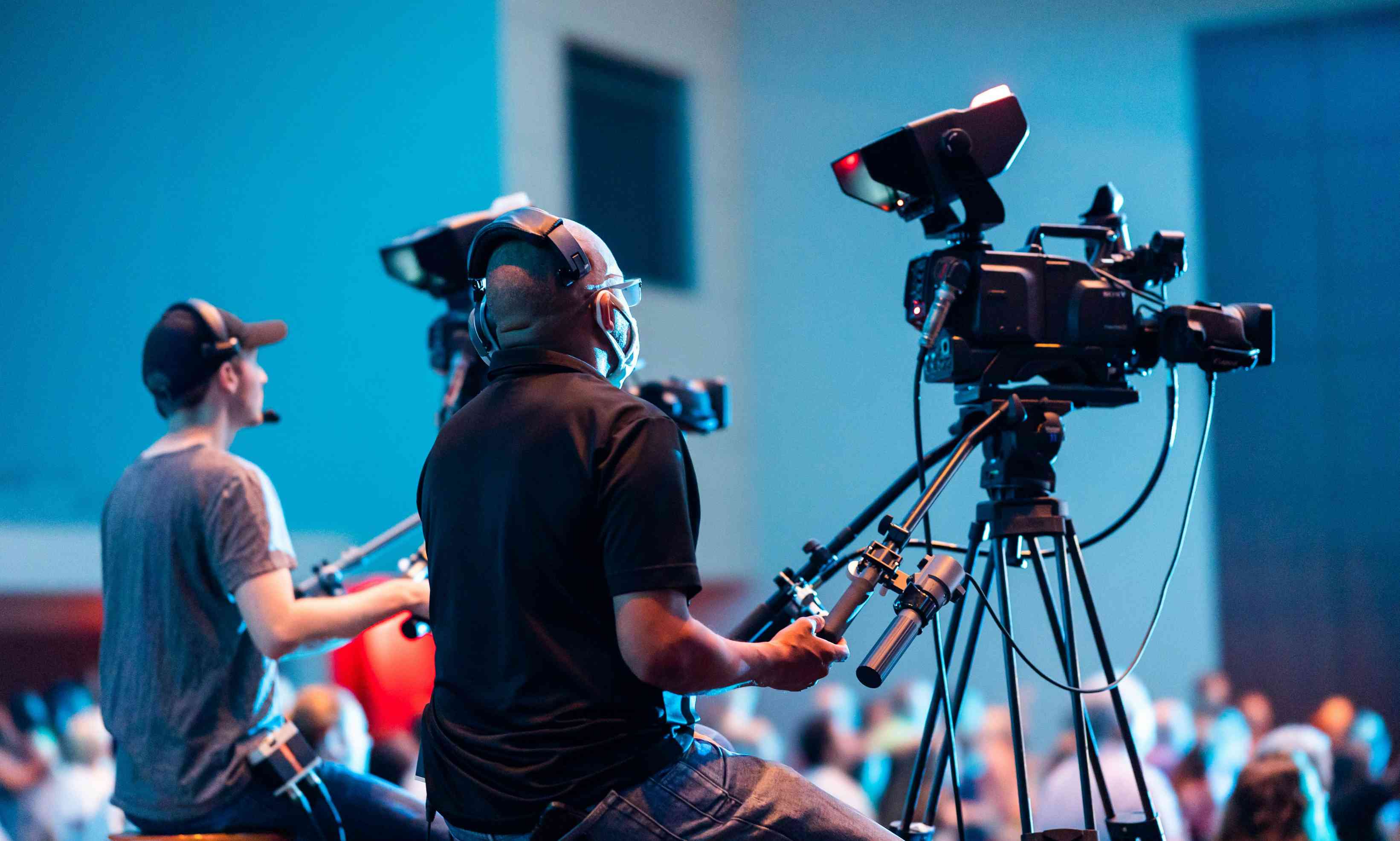 Professional camera operators capturing footage for live event video production