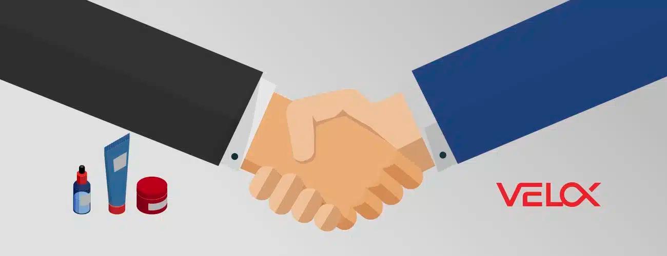 A large handshake with skincare products in the background