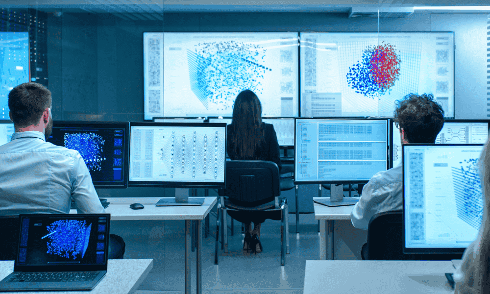 Team analyzing complex data visualizations in a high-tech workspace