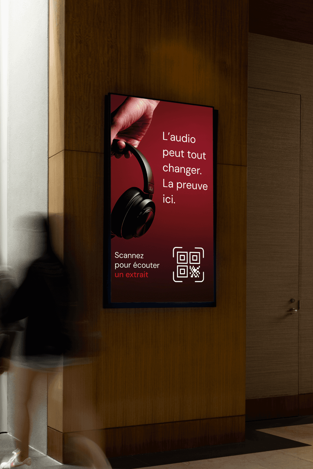A young man in a white shirt and tie sits on the floor, surrounded by scattered papers. He looks down at a document, appearing focused and pensive.