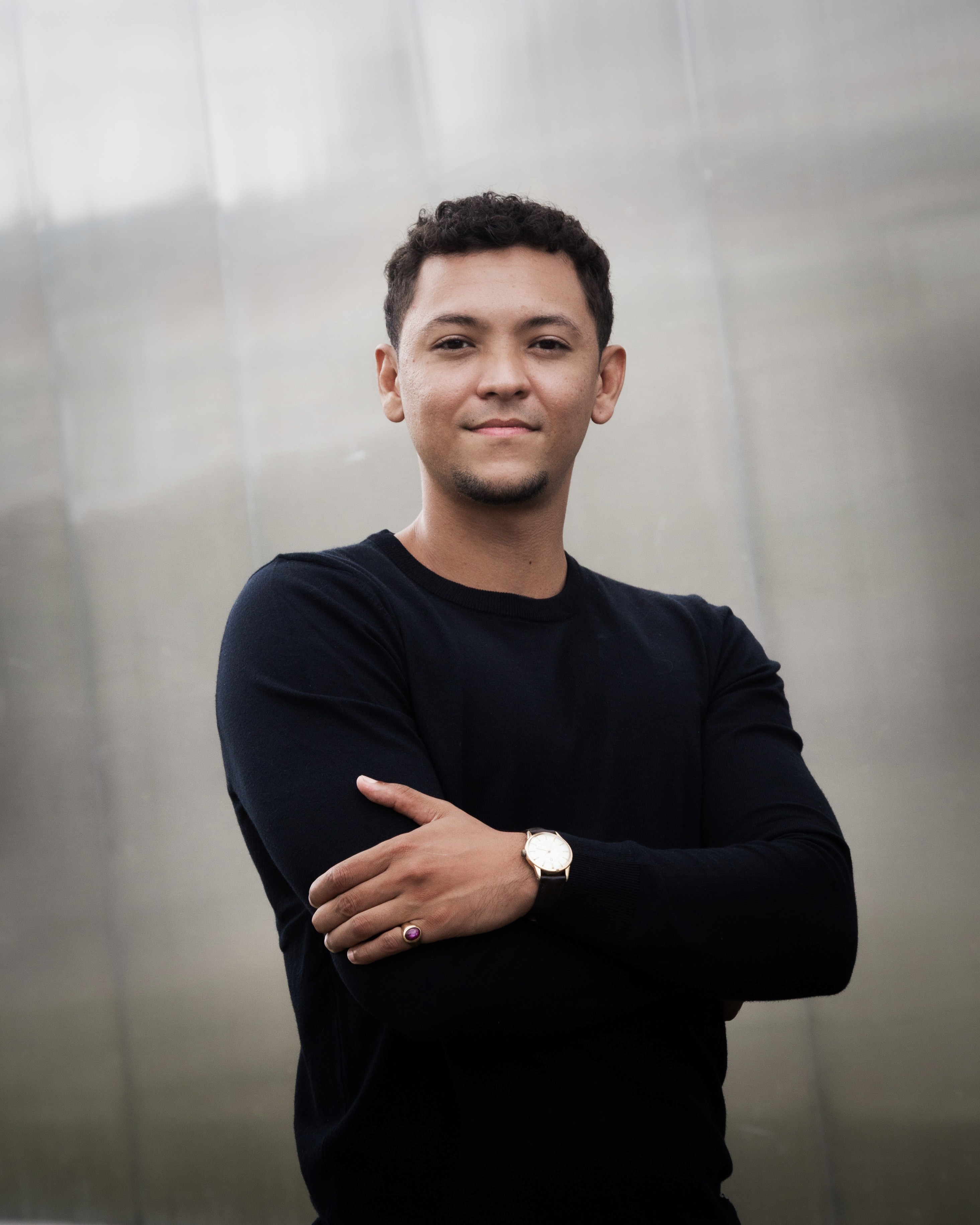 Black and white portrait of a smiling person with curly hair
