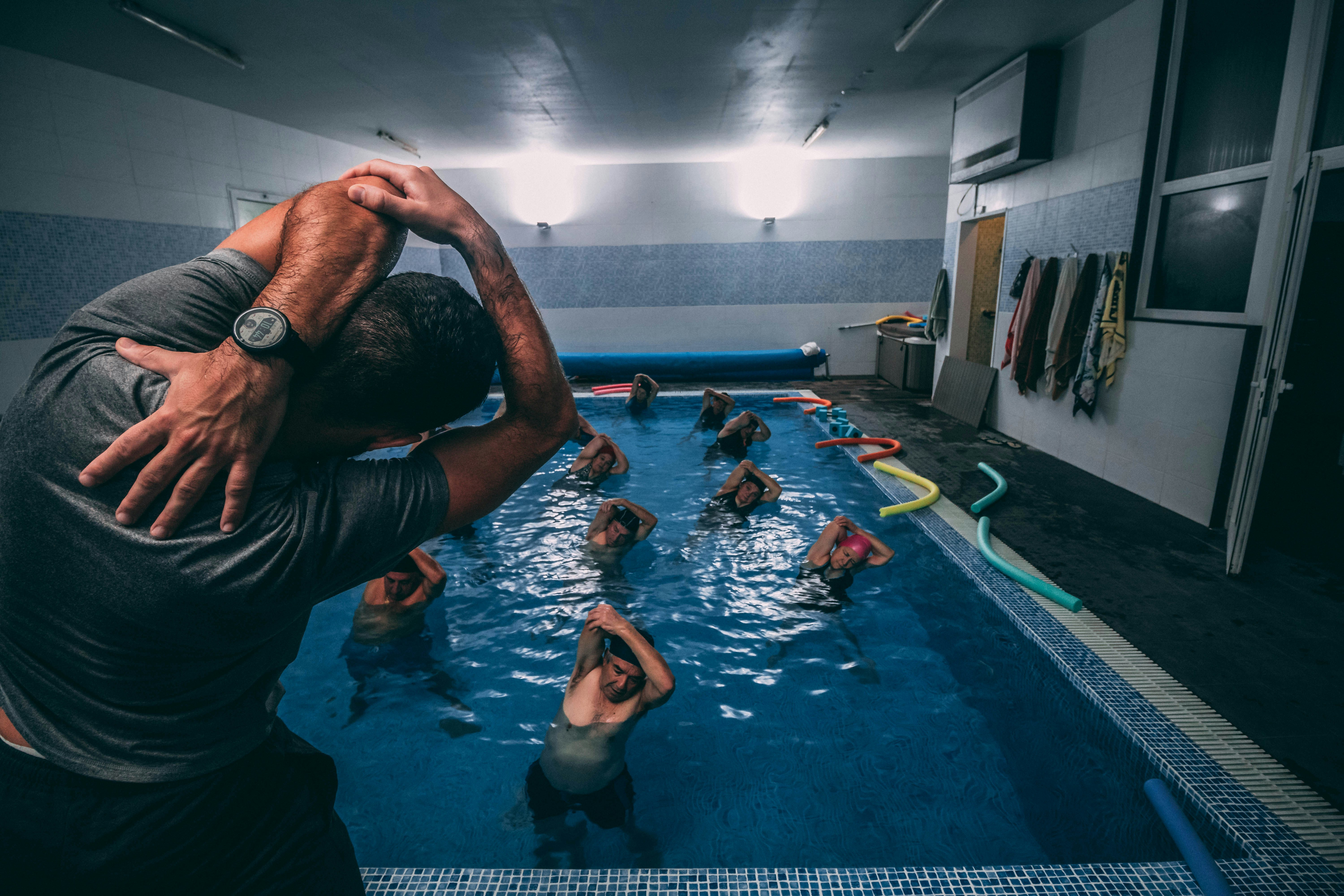 Personal Trainer Leading Swim Exercises Training