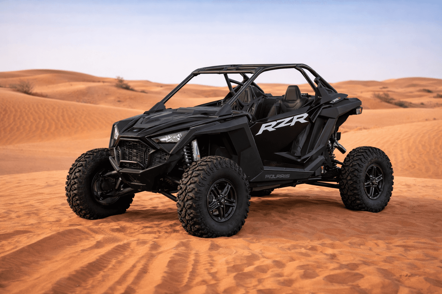 Black Polaris RZR Turbo R 2-seat off-road dune buggy from Dune Quest Tours during a buggy rental Dubai desert adventure