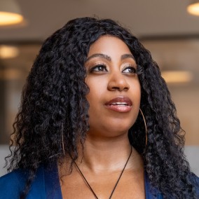 Possible member smiling and looking away from the camera.