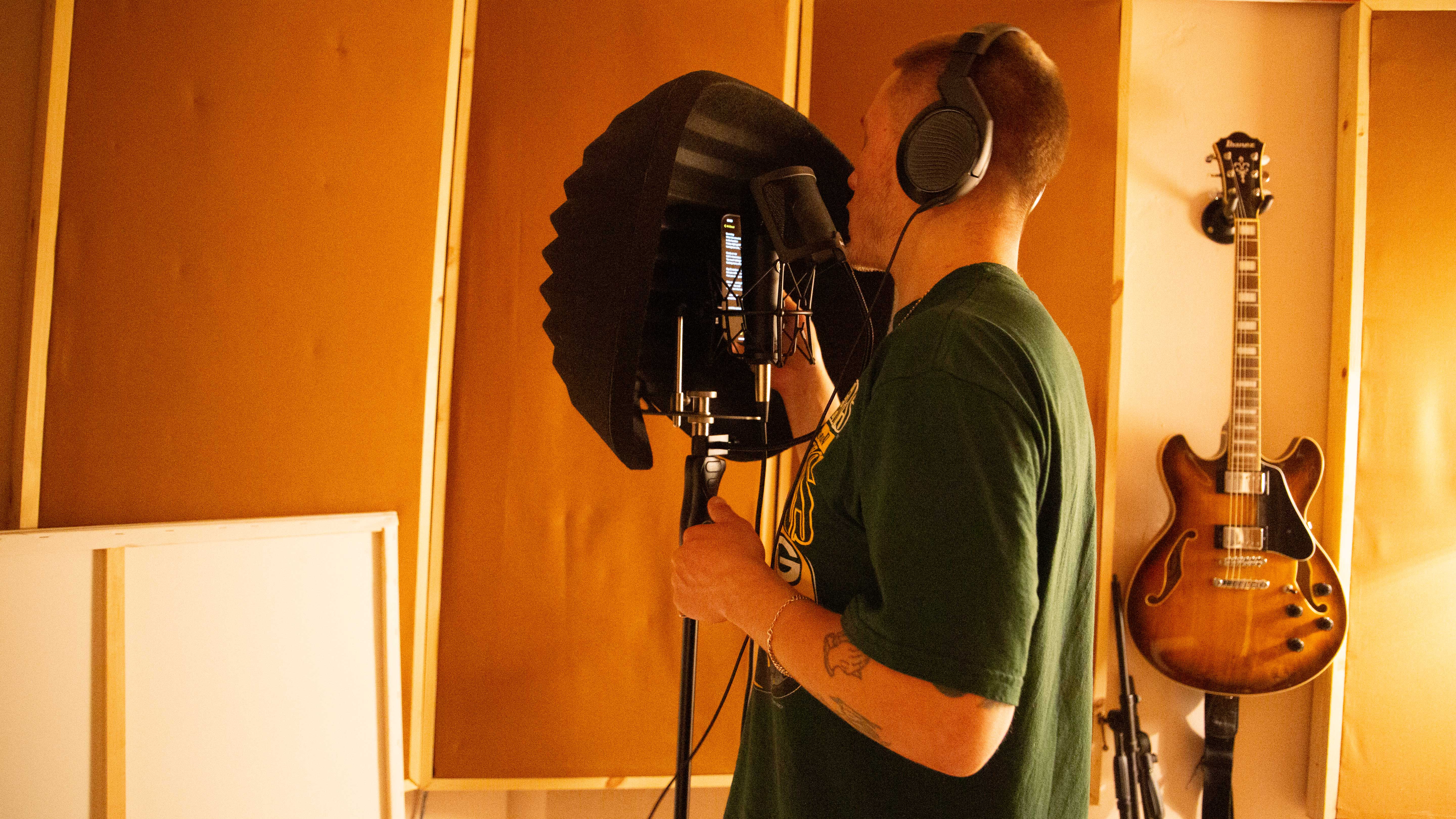 Artist recording vocals inside Root 73 studio.