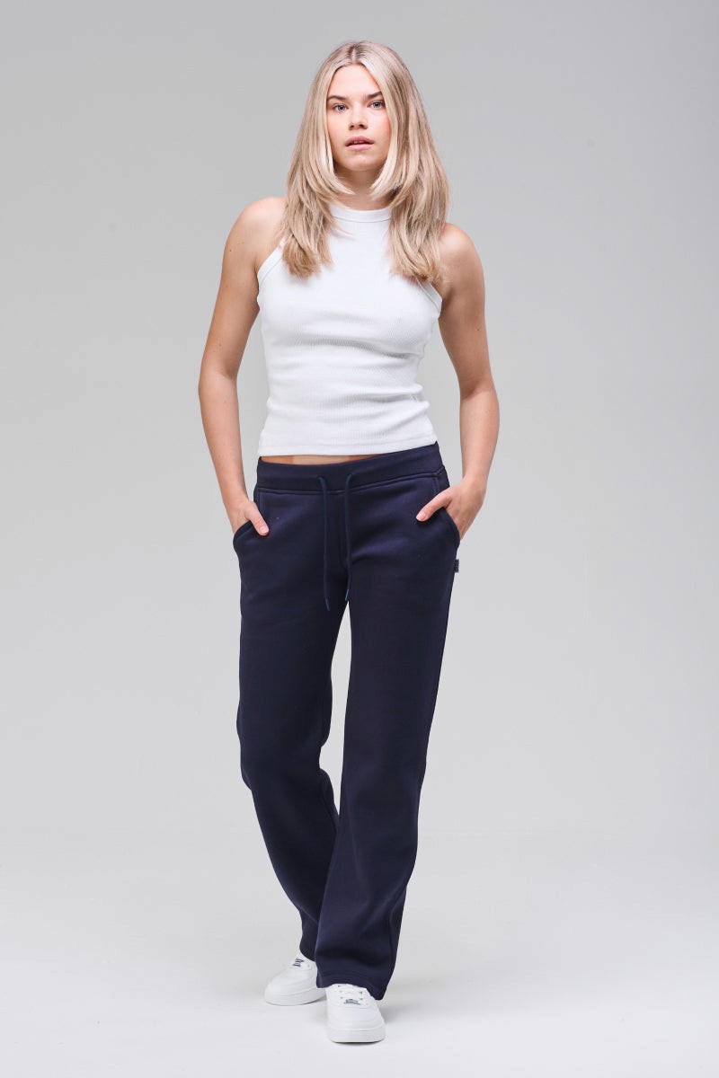 Model wearing navy straight leg sweatpants, full figure