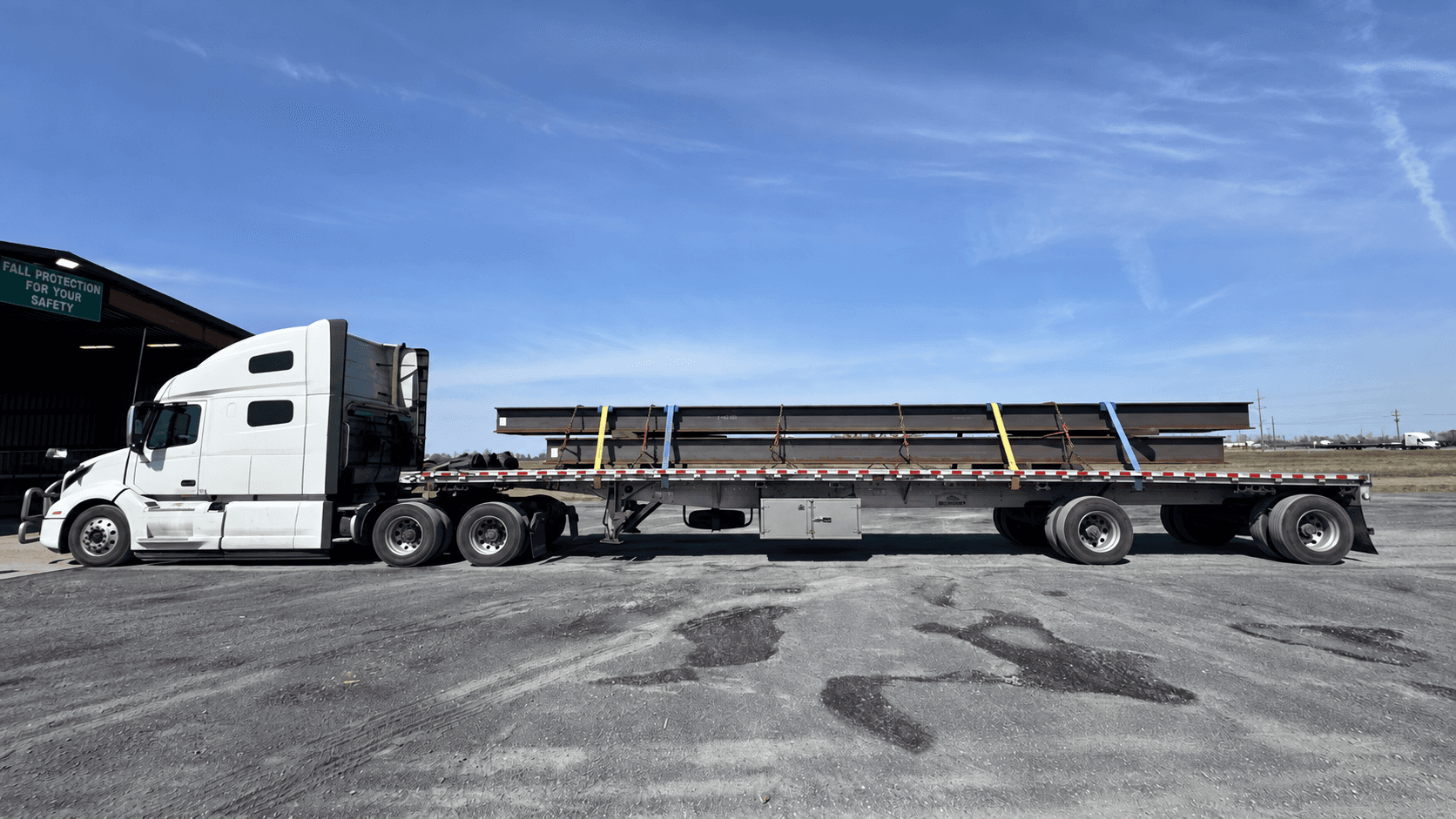 Structural steel beams on a flatbed trailer.