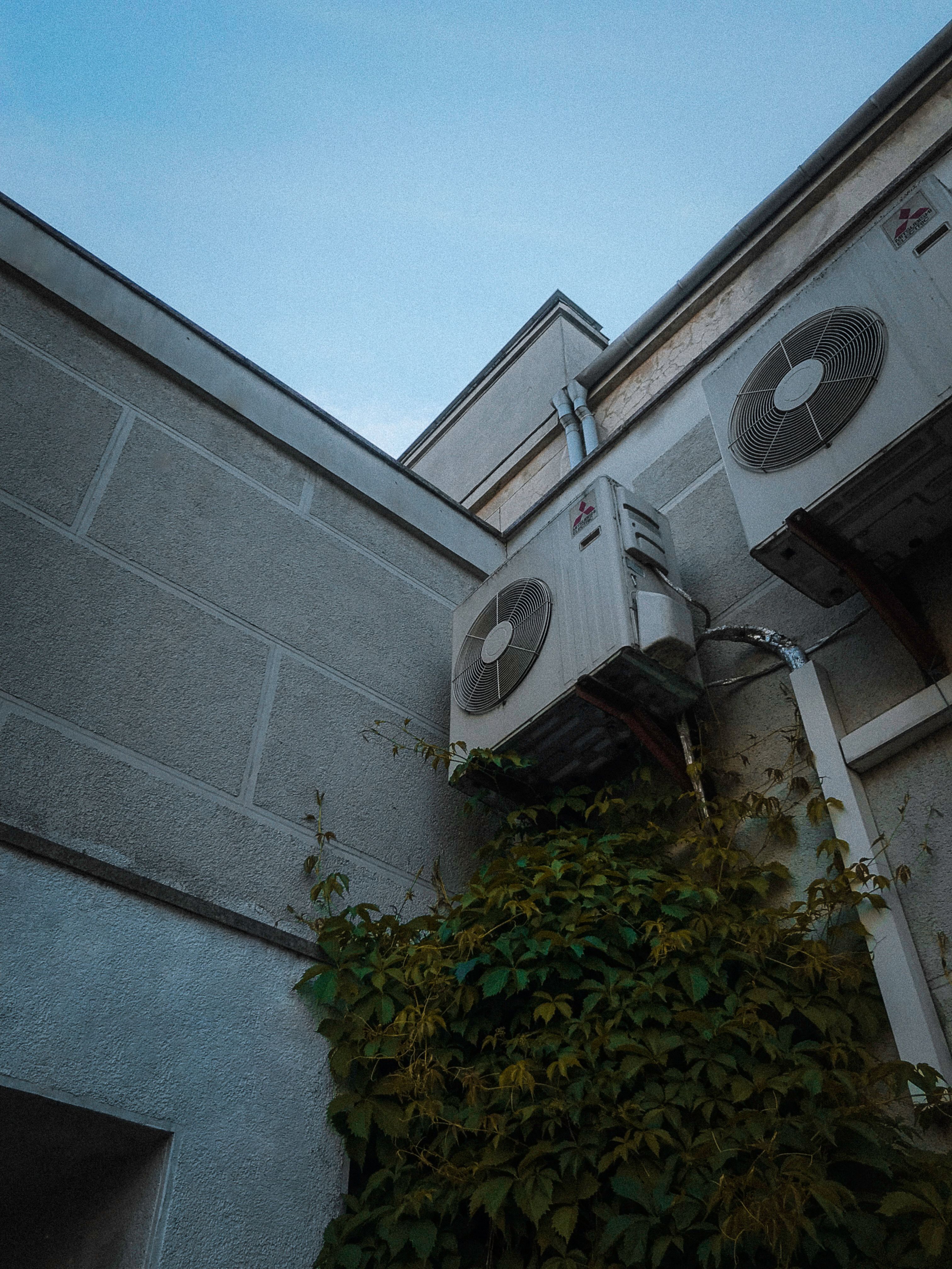 Two commercial airconditioner units on side of building