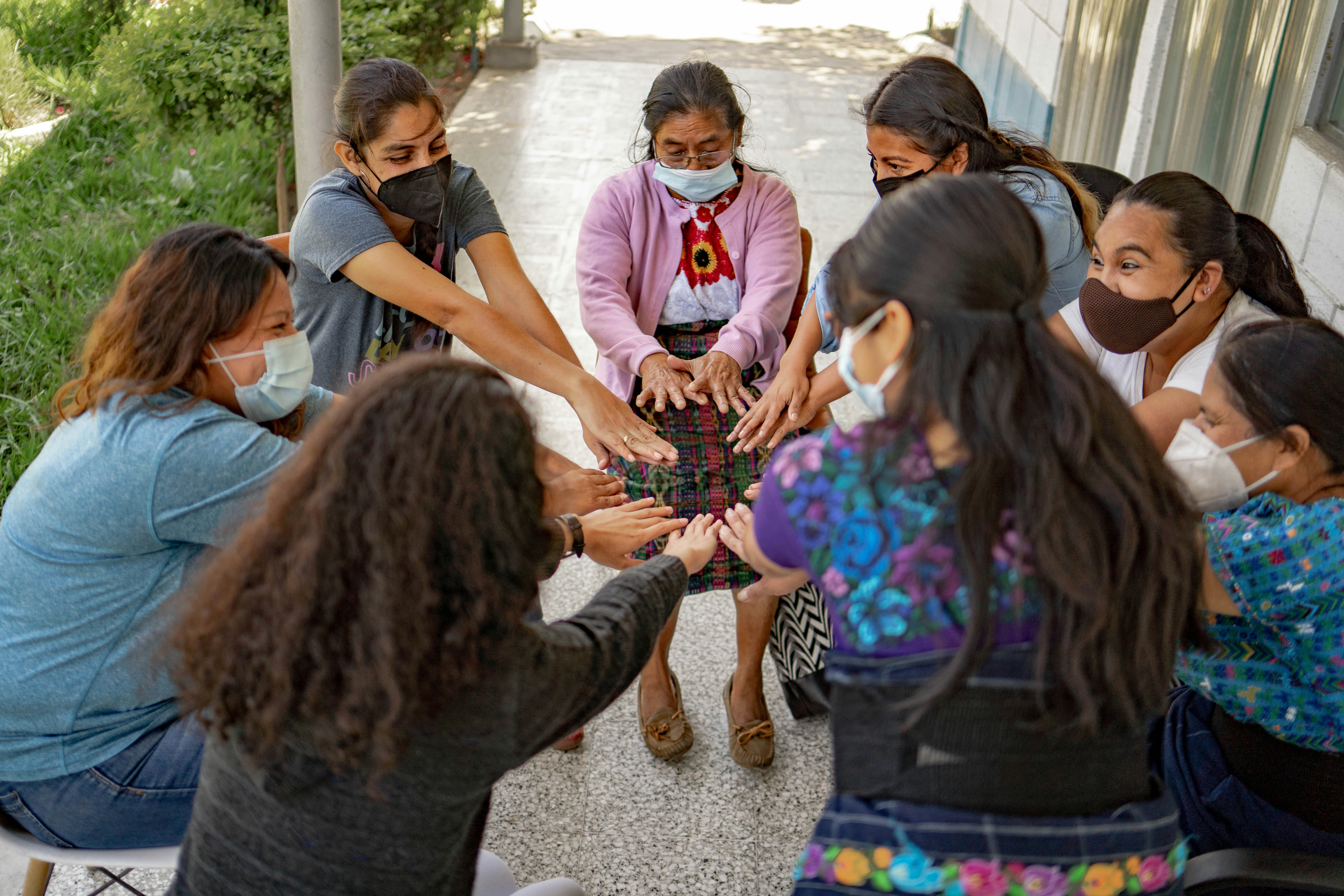 A group of people standing around each other