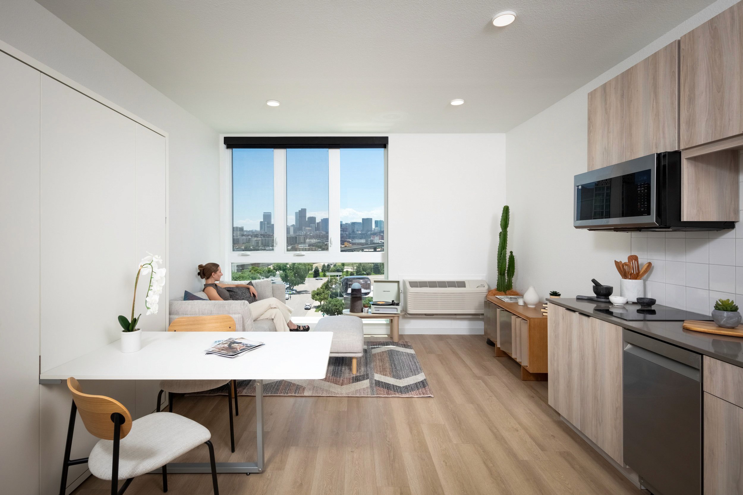 Woman on couch by window with city view