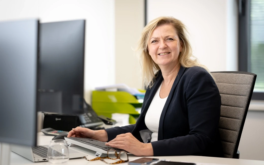 Front view of Dorine working in the office