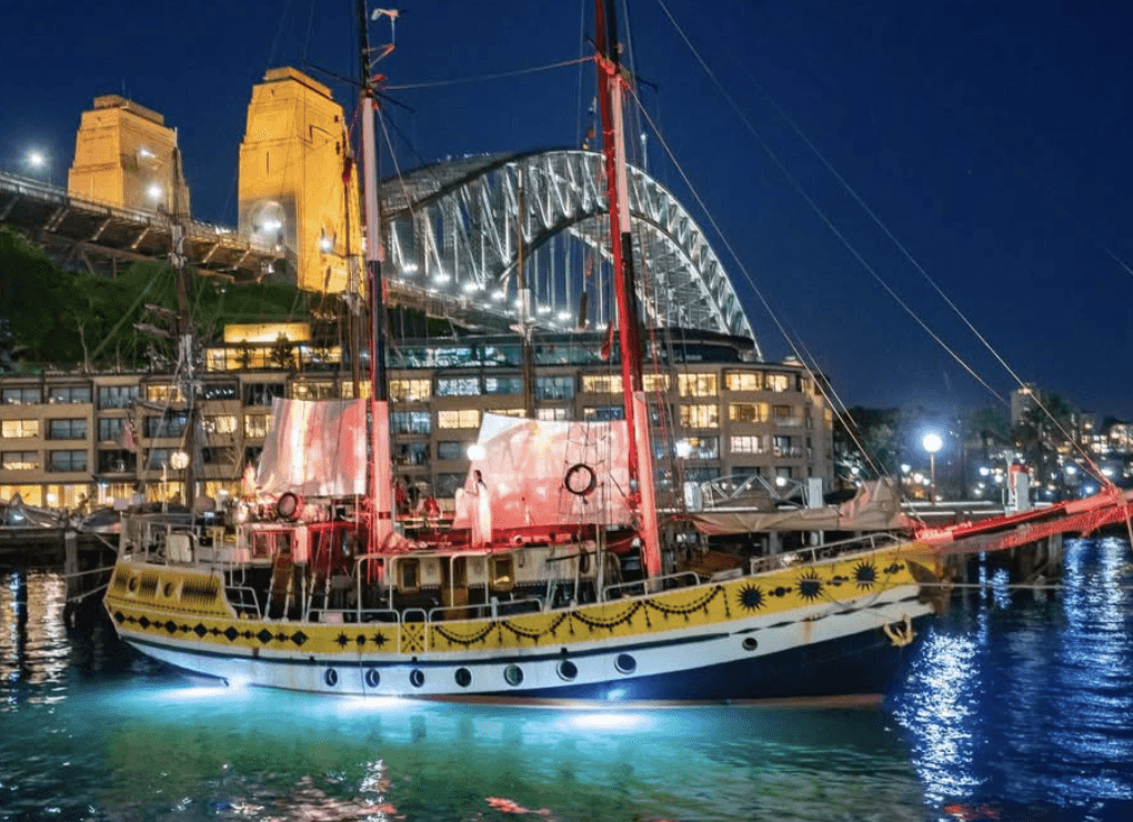 A man playing a drum in front of a group of people