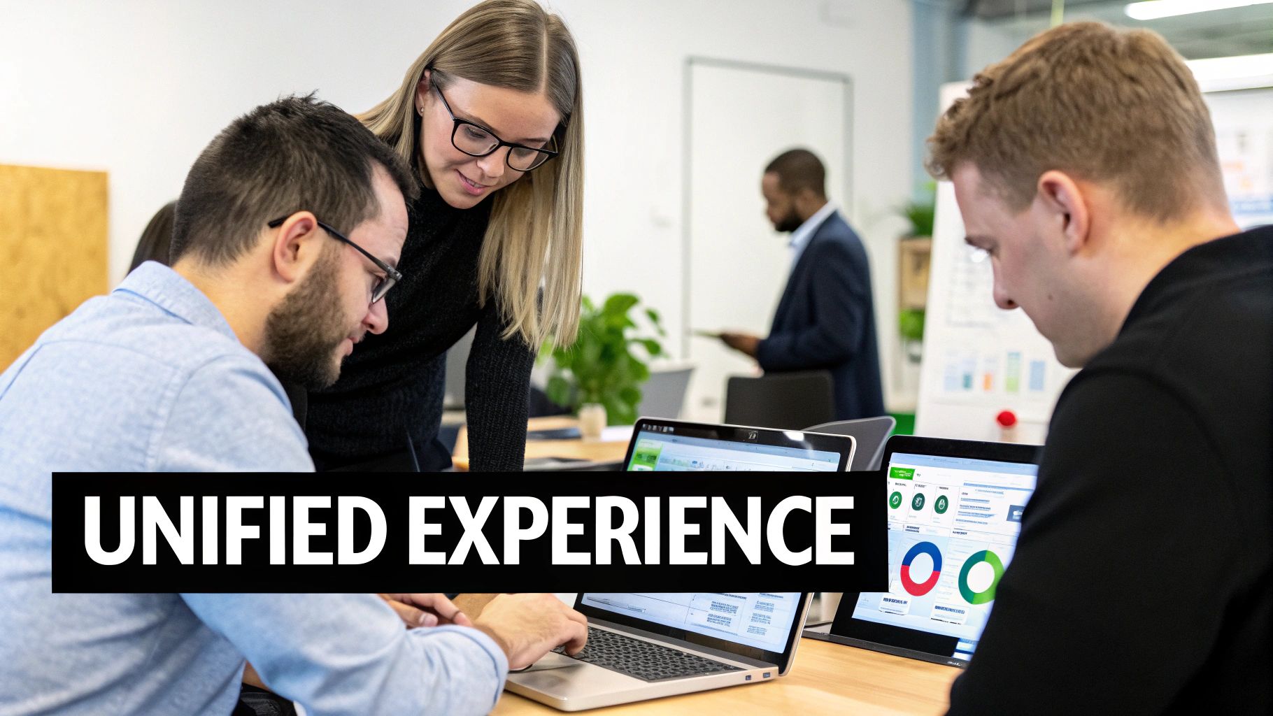 Three people collaborating in an office, looking at laptops displaying data and charts.