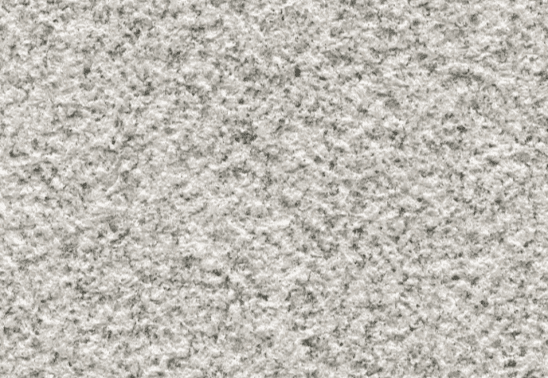 A detailed view of a light gray granite slab showcasing its rough, natural surface texture.