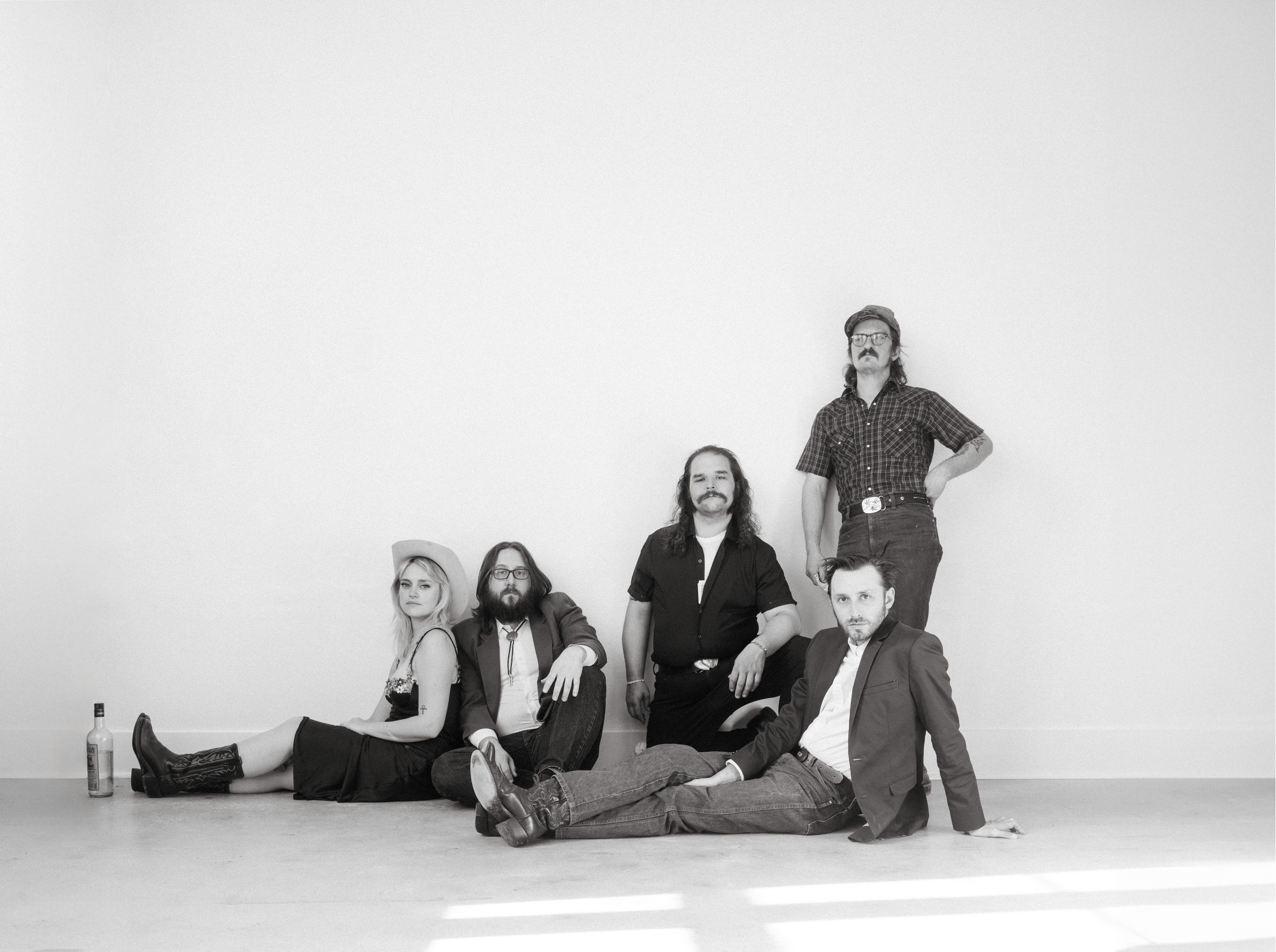 Guinevere Goodwin and band pose for a team photo in a shot inspired by Fleetwood Mac