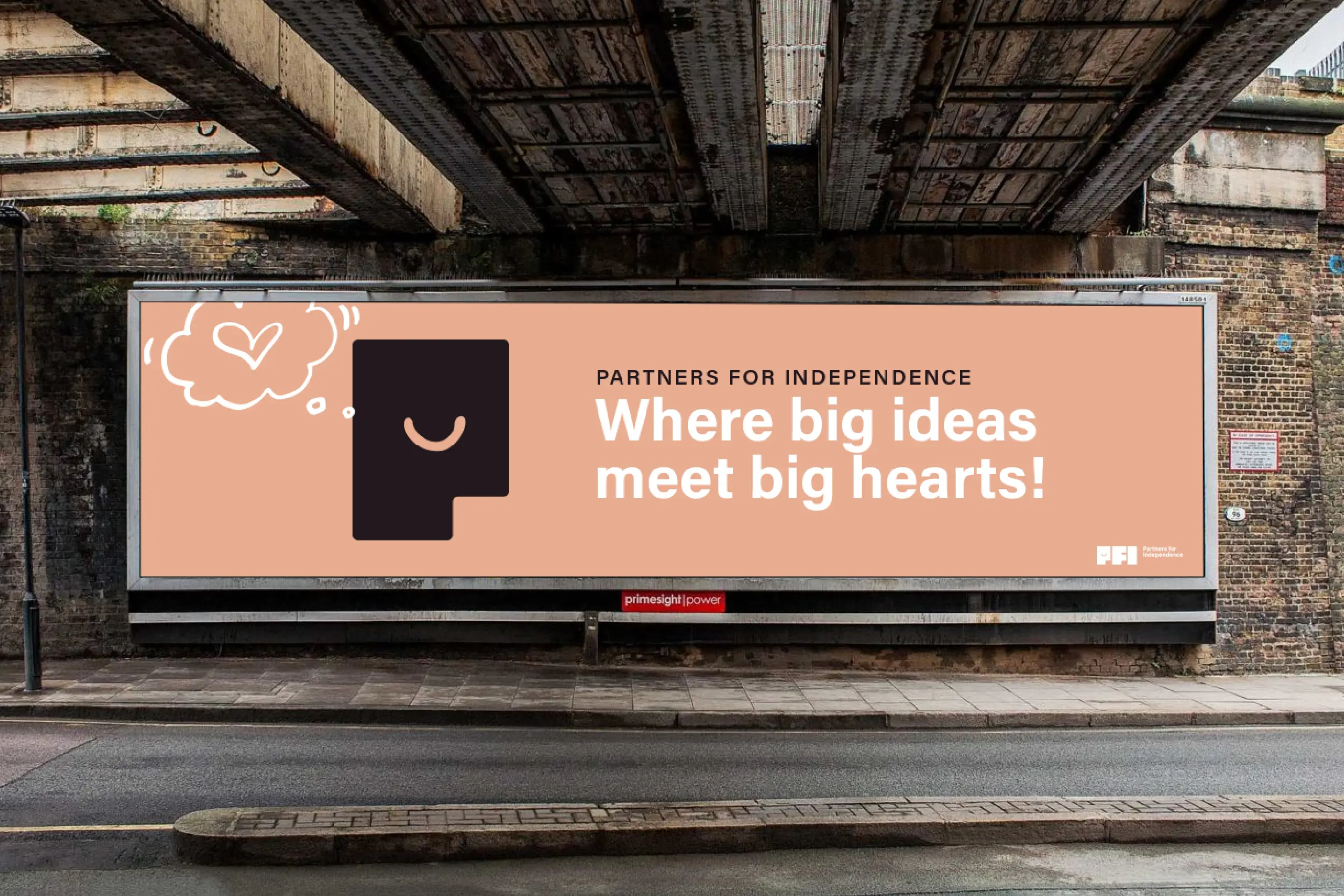 Partners for Independence billboard mockup featuring the headline “Where big ideas meet big hearts!” on a pink background.