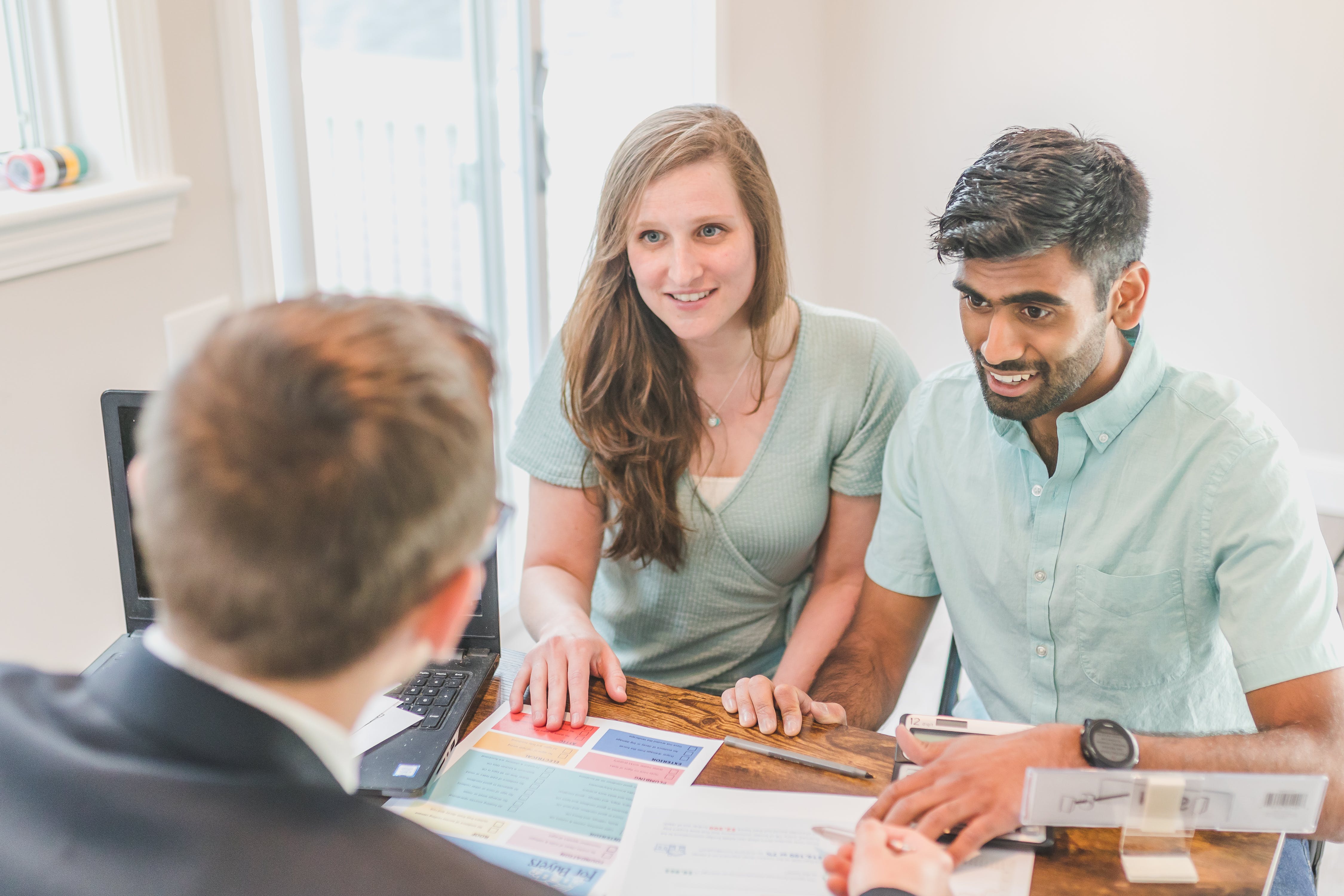 Happy couple talking to their broker