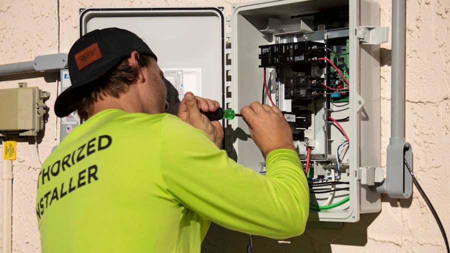 Electrician in a high-visibility uniform working inside an open circuit breaker panel