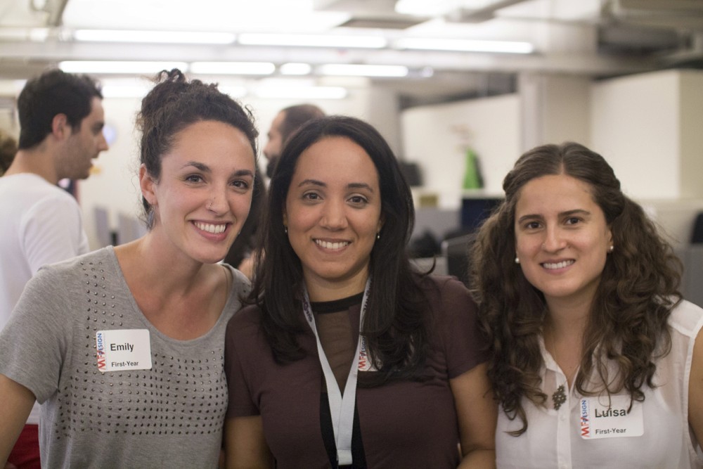 group photo of three students at the exhibition gallery