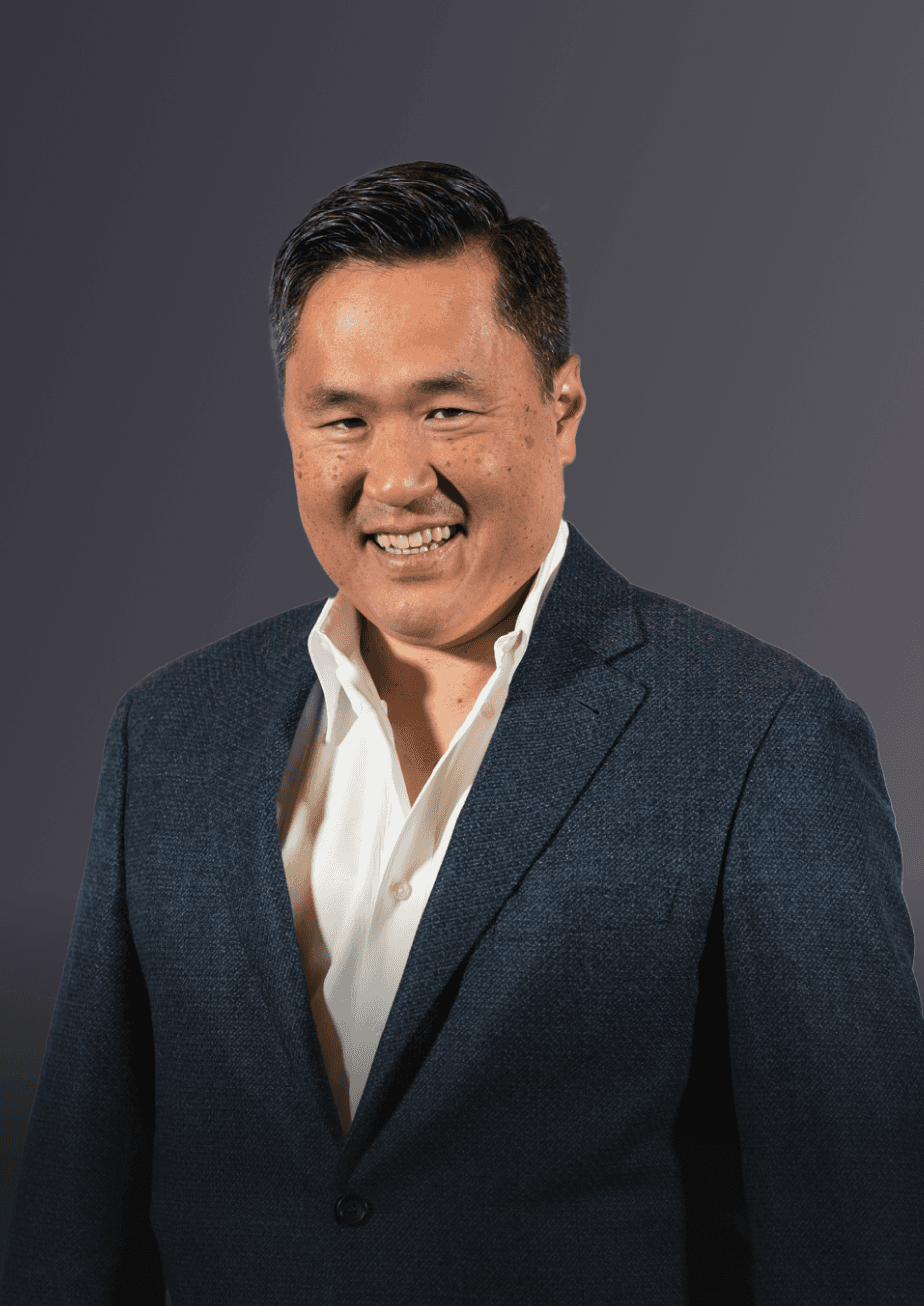 A serious smiling man dressed in a suit