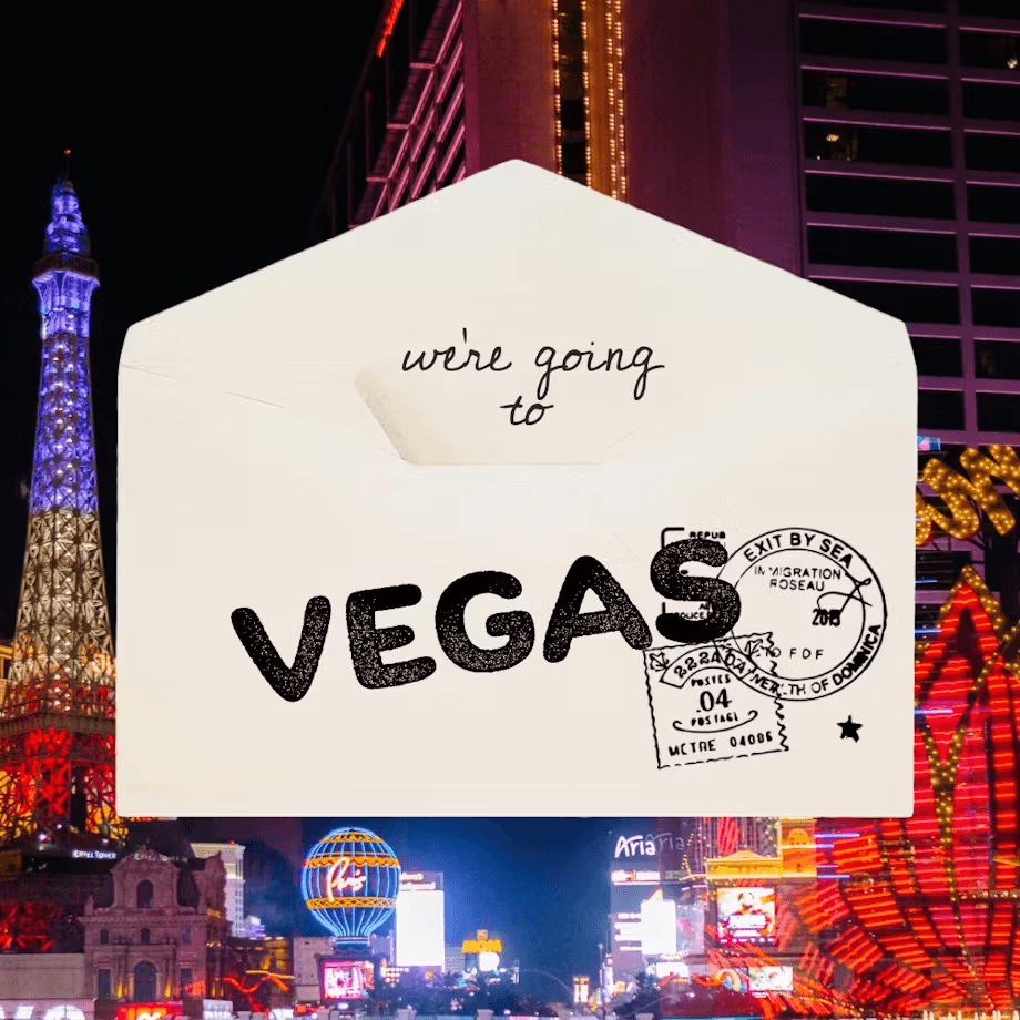 A postcard with "VEGAS" stamped on it, set against a colorful Las Vegas skyline backdrop.
