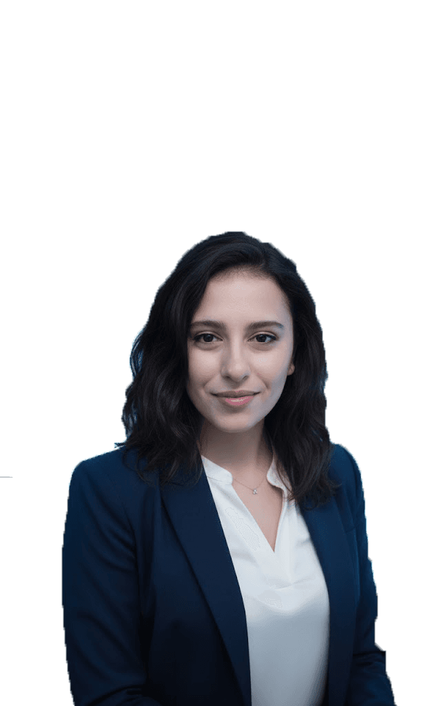 Professional woman in a suit standing in an office setting.