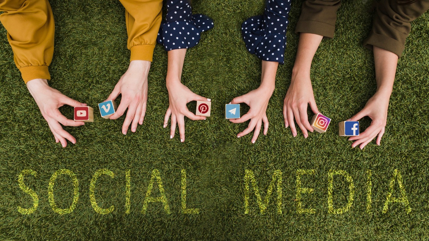 A pair of hands placed on lush grass, representing the theme of social media and nature's tranquility.