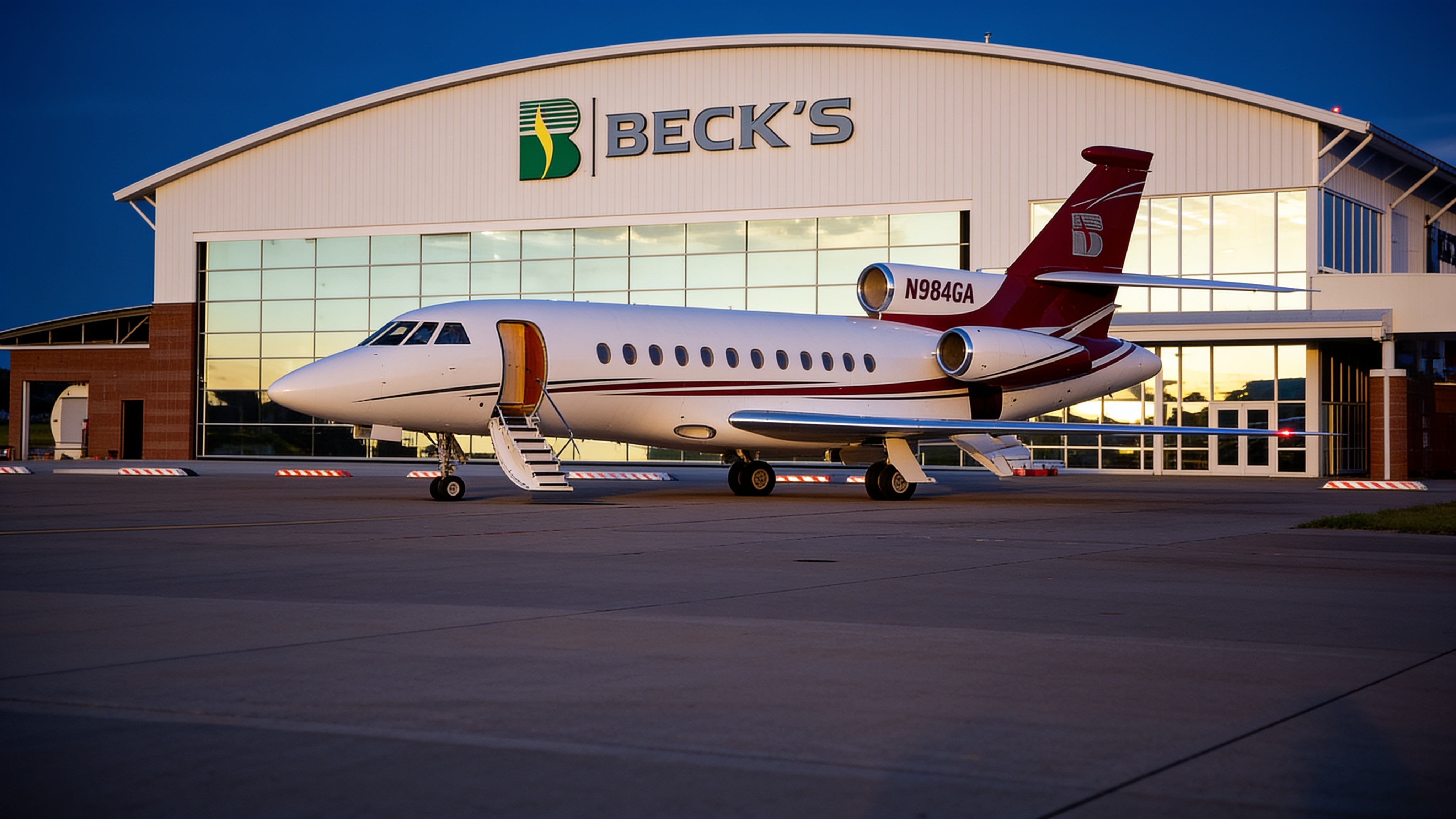 Exterior of a glass-front hangar with a PowerLift hydraulic door lifting open