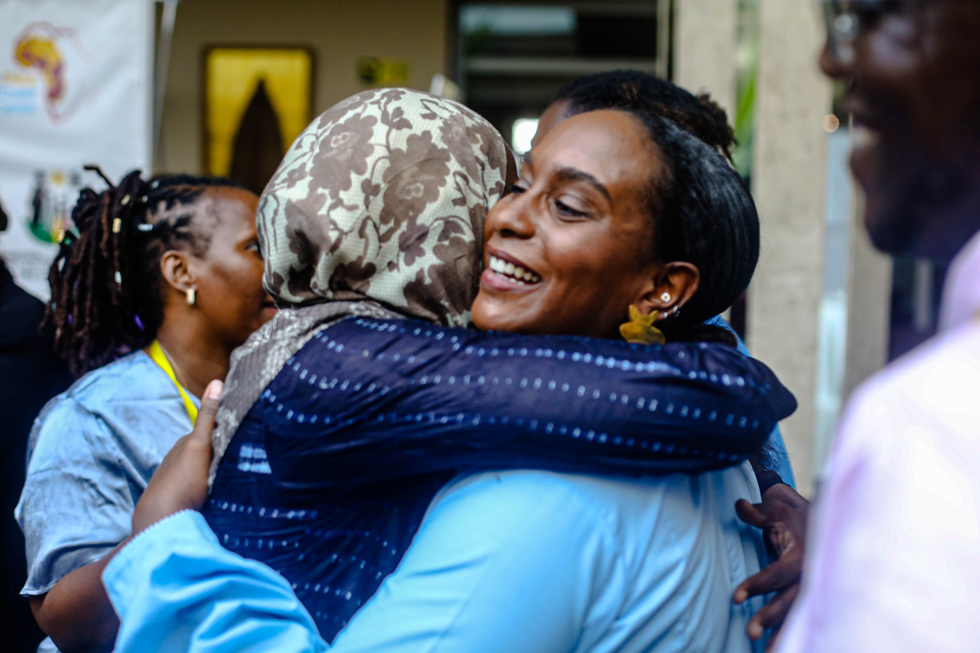 Three children jumping in burlap sacks during a race.