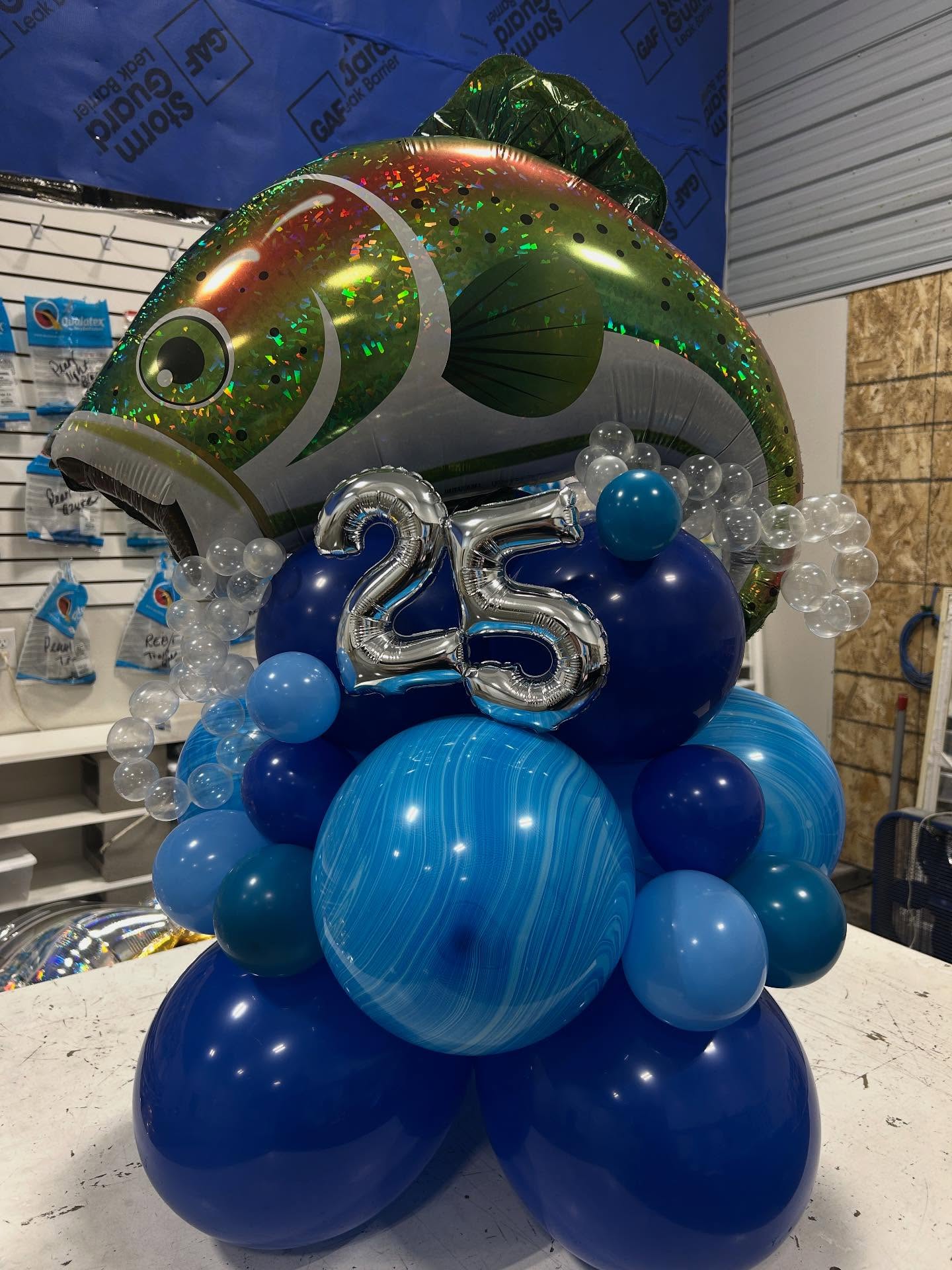 Blue balloon base with silver number 25 balloons and colorful accents celebrating an anniversary or milestone by Be Bold Balloons