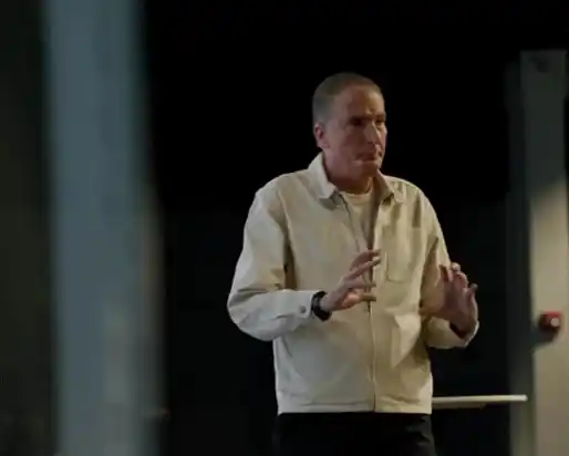 Pastor speaking on stage during a Sunday service