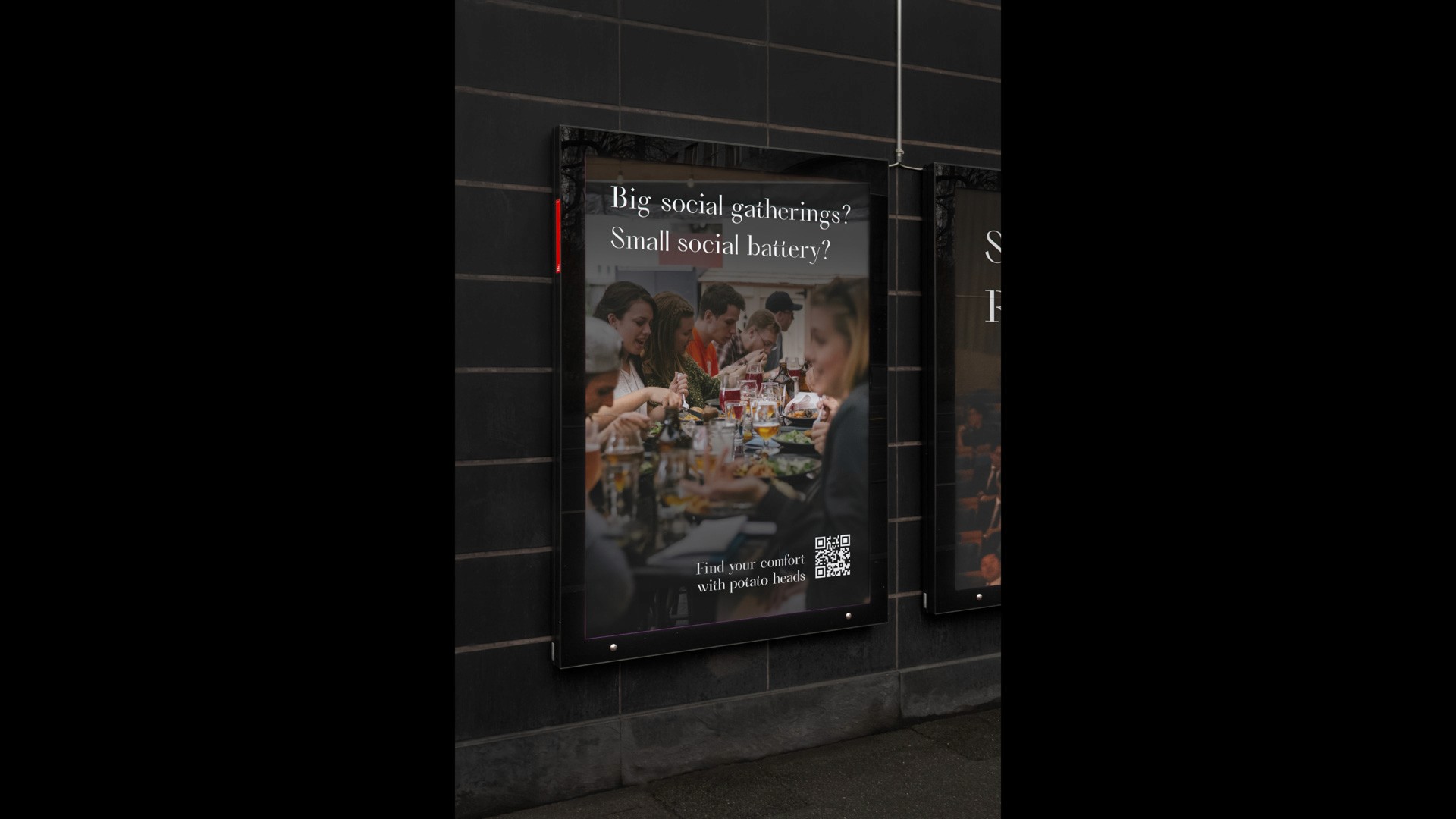 A framed poster on a dark tiled wall displays a photograph of a group of people gathered around a table, eating and drinking. The text on the poster reads “Big social gatherings? Small social battery?” and includes a QR code with the instruction “Find your comfort with potato heads.”