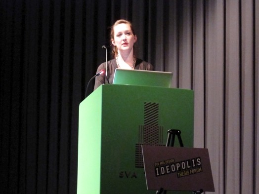 a woman is giving a speech form the green stand