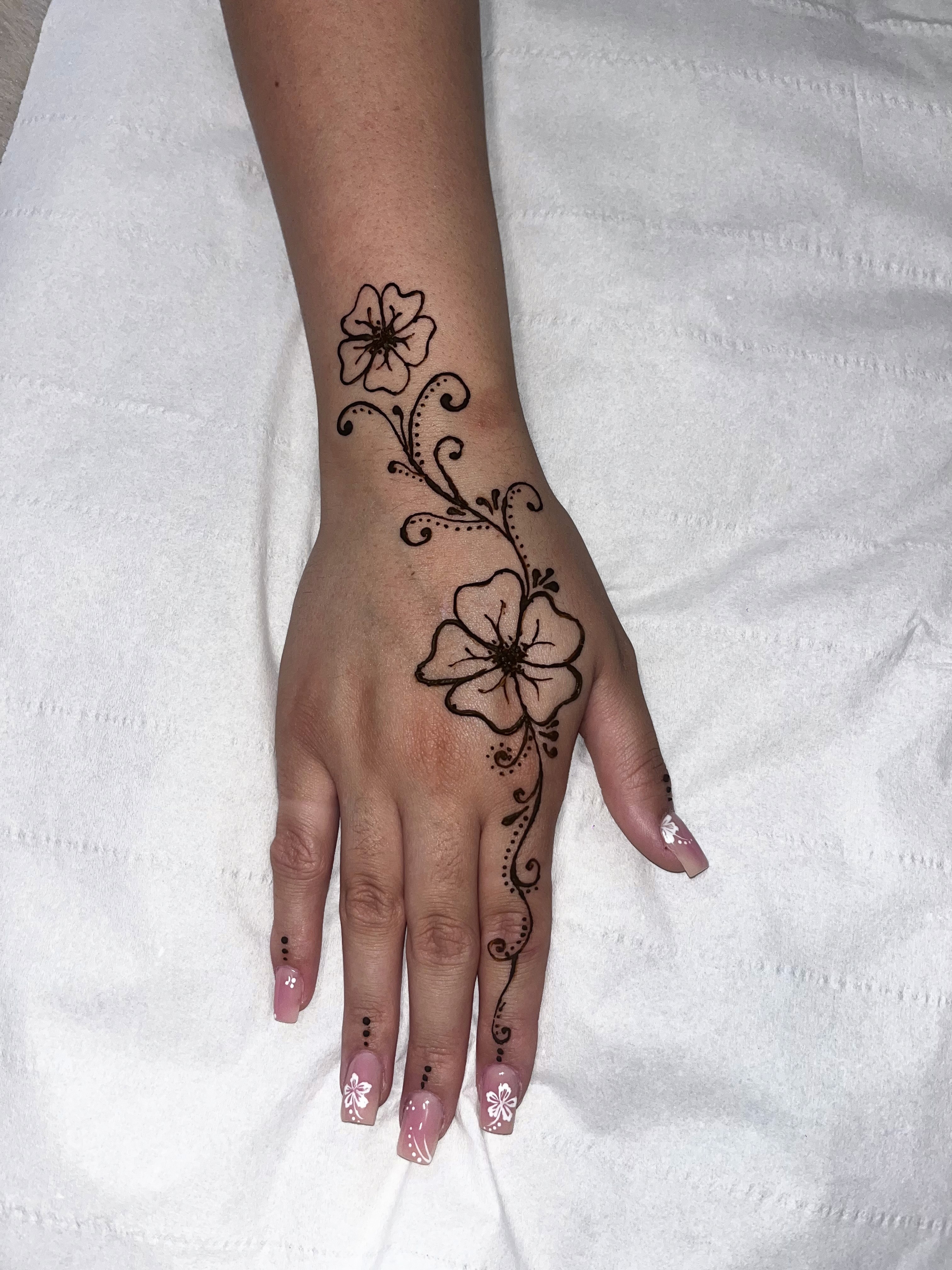 floral design henna up hand and wrist