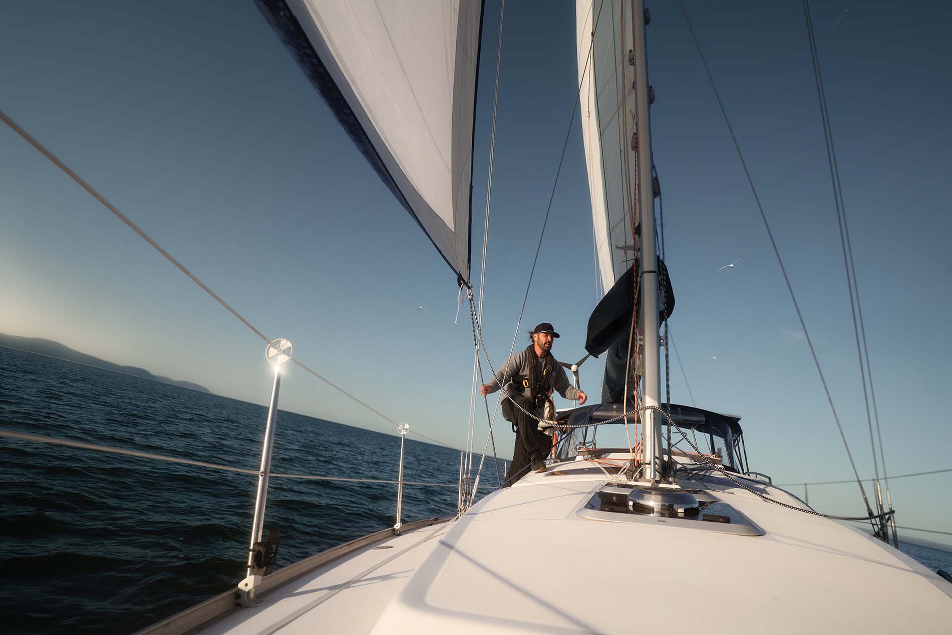 POV from a boat with a person sailing at sunset.