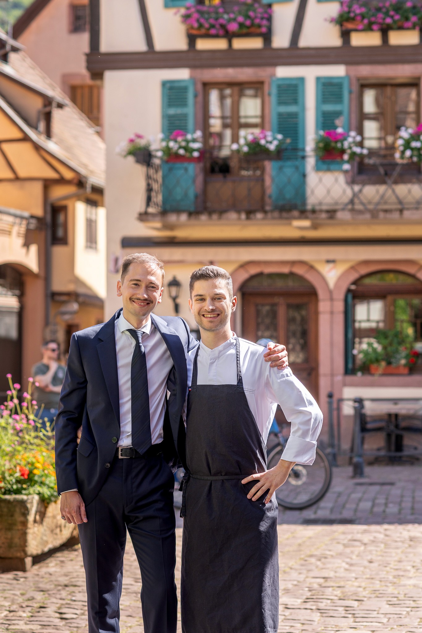 Portrait of the head chef standing at the restaurant entrance.