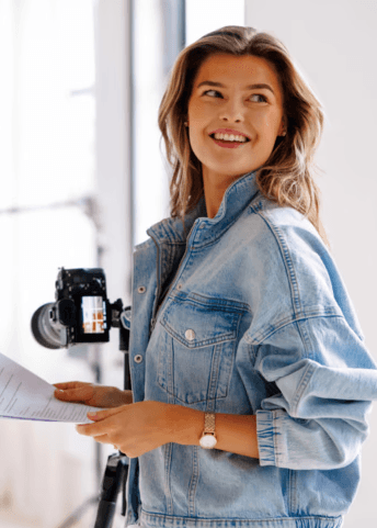 Dried herbs hang near a window with a quote.