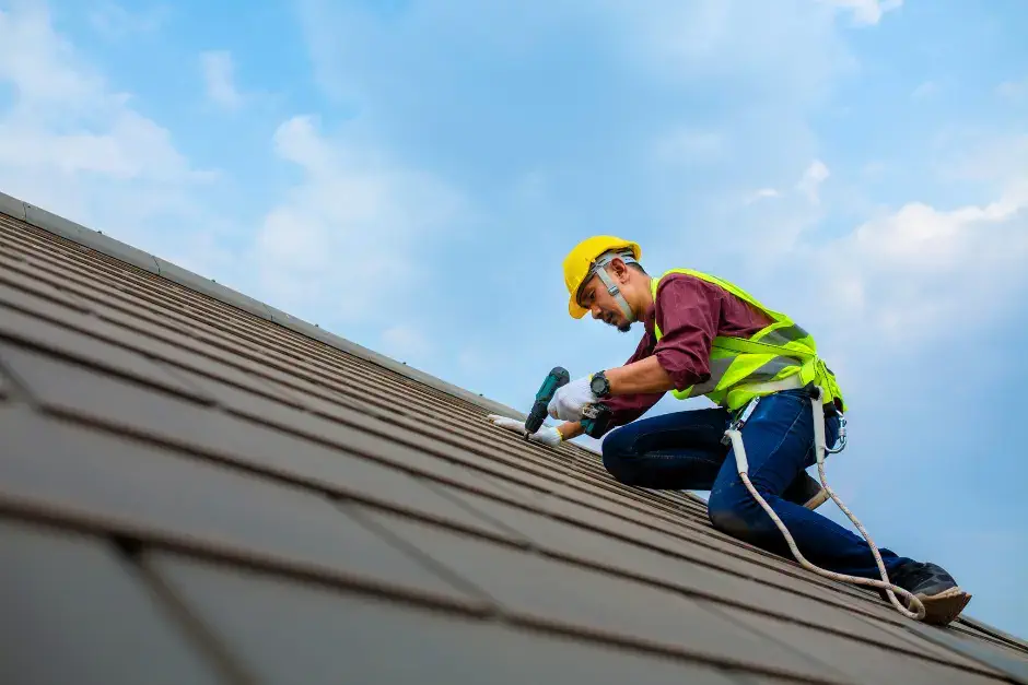 portrait of roofer focused on repairing roof