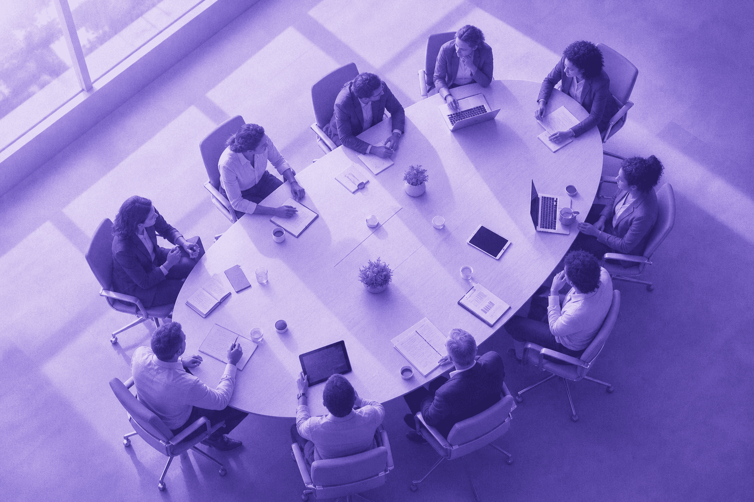 A top-down aerial view of a large modern corporate boardroom with multiple diverse business professionals seated around an oval conference table, each person representing a different organizational role — some in formal business attire, some in smart casual — with laptops, tablets, and documents spread across the table. The scene conveys a complex multi-stakeholder enterprise decision-making meeting. Soft natural light from floor-to-ceiling windows, clean minimalist office aesthetic, photorealistic style.